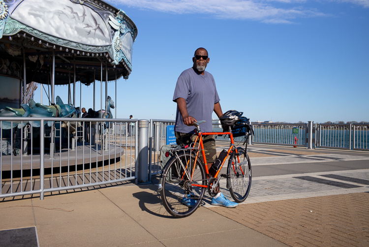 Henry Ford II stands with his bike by Detroit's riverfront.