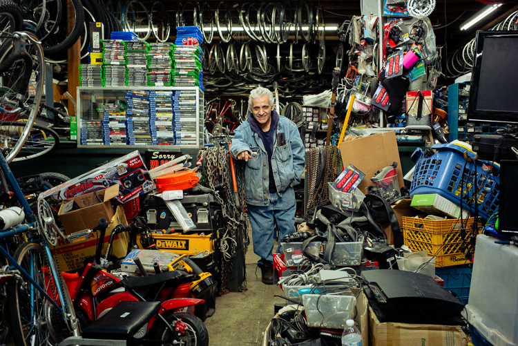 Sam Awada poses with merchandise at Livernois Bike Shop.