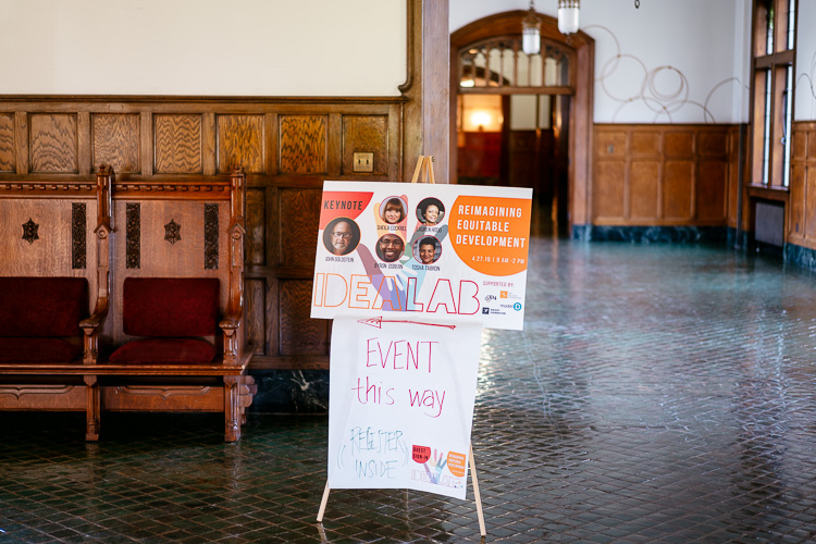 A sign points the way to the event.