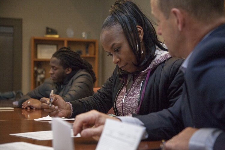 Katrina Johnson signs paperwork for a mortgage on her home in Newberry.