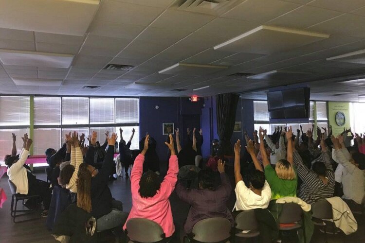 A group of seniors involved with LifeBUIILDERS join together in prayer prior to the pandemic.