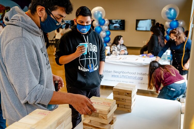 Youth play a jenga-type game at LOS HQ opening.