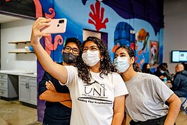 Youth involved with UNI take a selfie at the LOS HQ opening.
