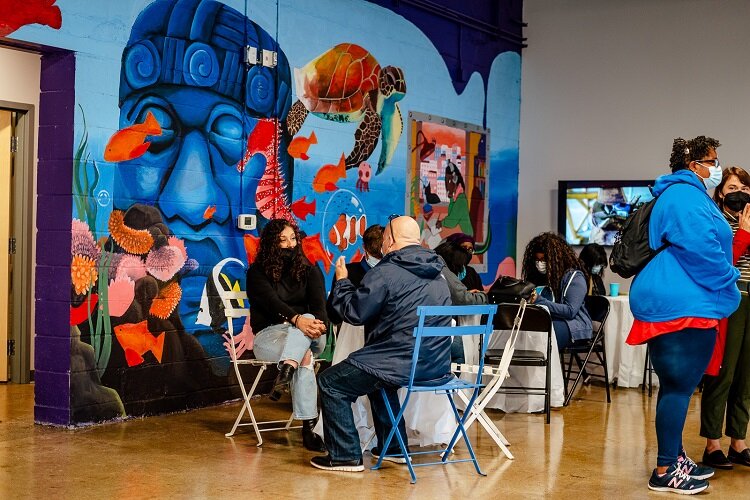 Visitors check out a mural at the LOS HQ soft opening.