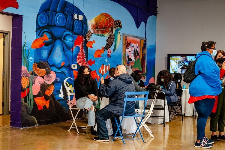 Visitors check out a mural at the LOS HQ soft opening.