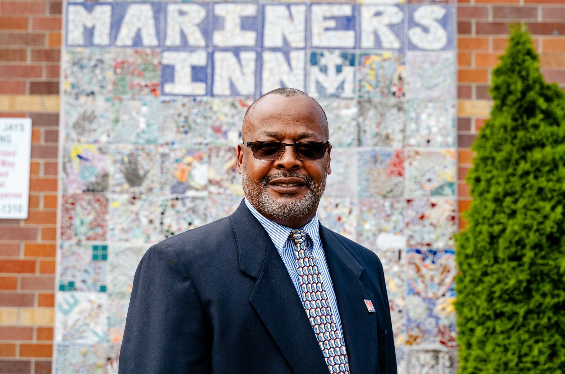 David Sampson, CEO of Mariners Inn, stands in front of a building that is part of a redevelopment project that will enable his organization to provide seamless transitions to affordable housing for the clients served.