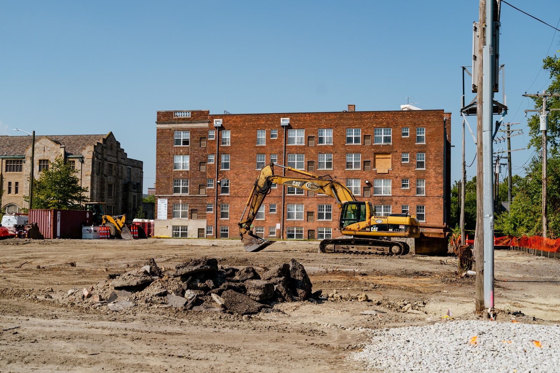 A bulldozer turns dirt at the back of the Marwood apartment building.