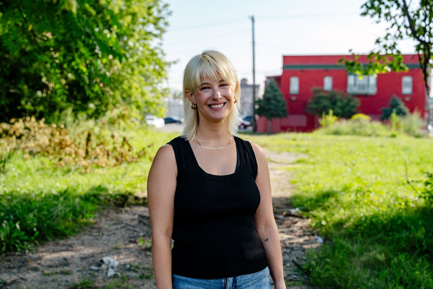 Martha Potere stands in an abandoned lot that will soon be home to the La Joya Gardens, a mixed-use development that includes affordable housing units.