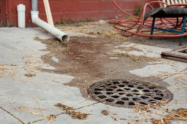 A downspout leading directly to a storm drain