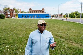 Ponce Clay stands on a stretch of real estate he owns in Detroit.