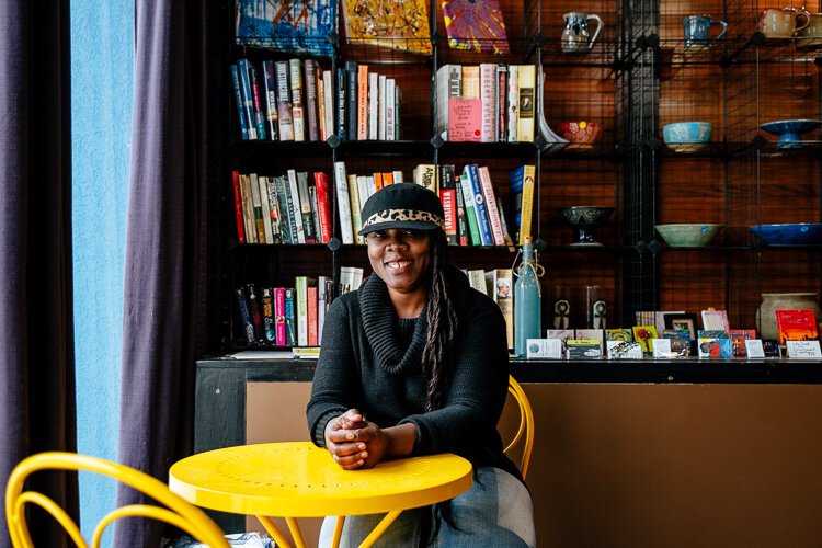 Denise Warren sits at a table at ZAB Cultural Collective.