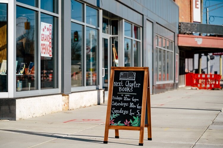 A sandwich board advertising Next Chapter Books.