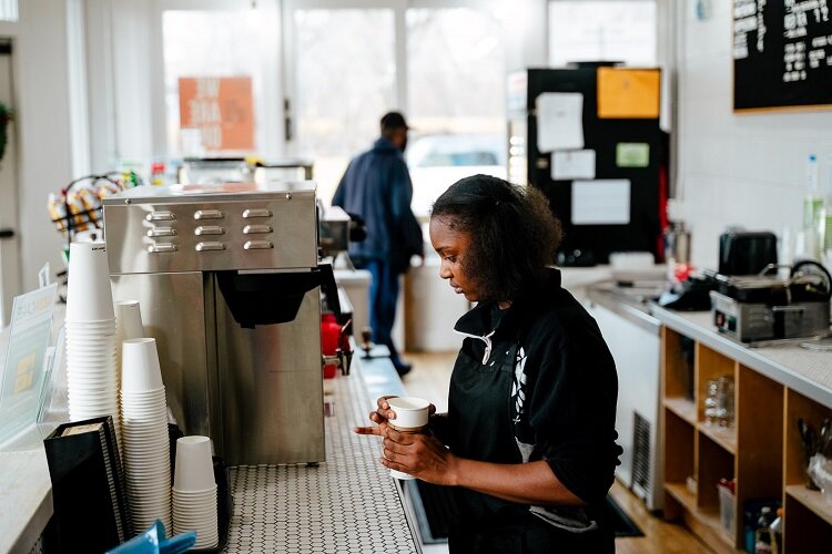 Barista Ashanta Watkins, 18, readies a coffee cup for a customer at The Commons.