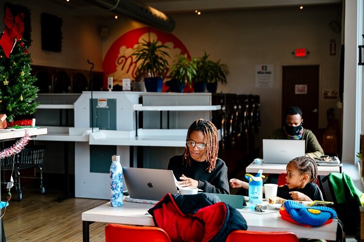  Rukiya Colvin, 32, and her son Tupac, 3, sit at a table at The Commons.