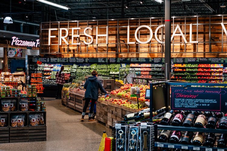 A shopper checks out produce at Rivertown Market.