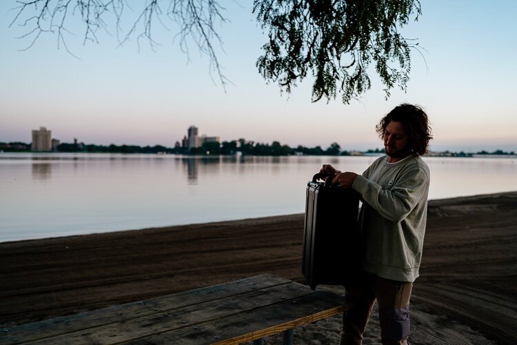 Matt Morris sets up James Oliver coffee at a picnic table near the Belle Isle Swim Club's meeting spot on the beach.