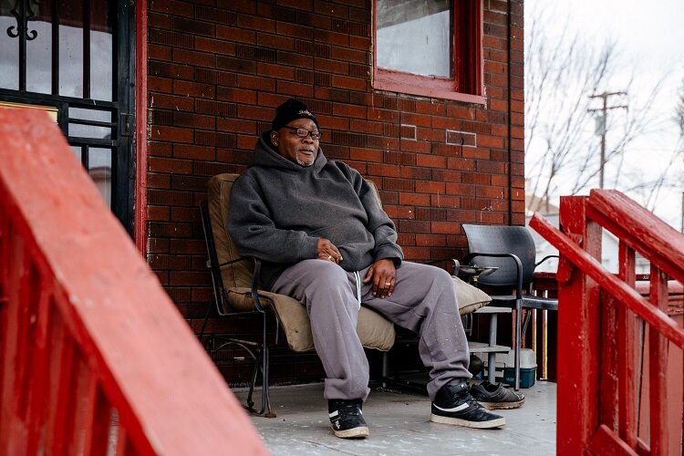 Kenny Tanner sits on his porch.