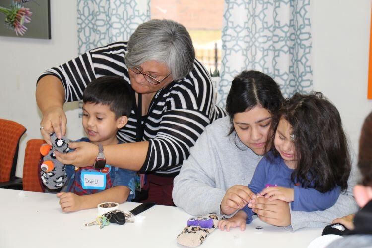 Tipton and parents help children create puppets used for self-talk.