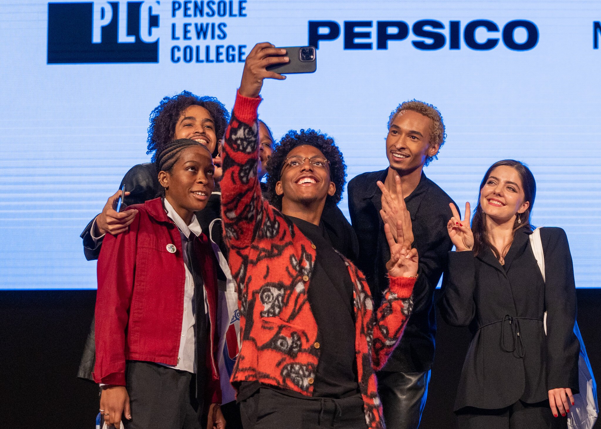 Pensole Lewis students celebrate with a selfie on stage.jpeg