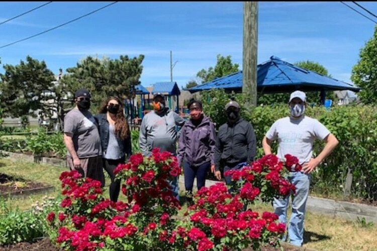 Members of the HRRA pose in front of their community garden at Stanton Park.