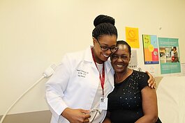 Dr. Kai Palm hugs a patient at Covenant's Joy Road Clinic.