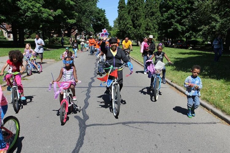 Members of the NRPCA take local youth on a costumed bike ride.