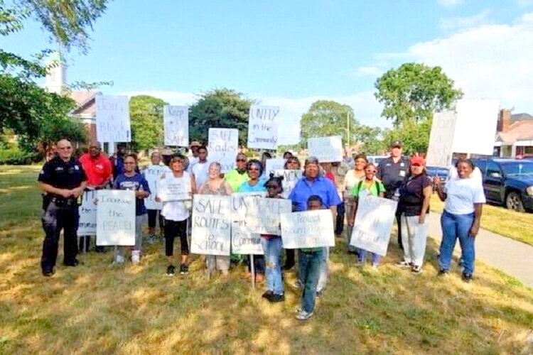 Neighbors with the Regent Park Community Association march for a safer community.