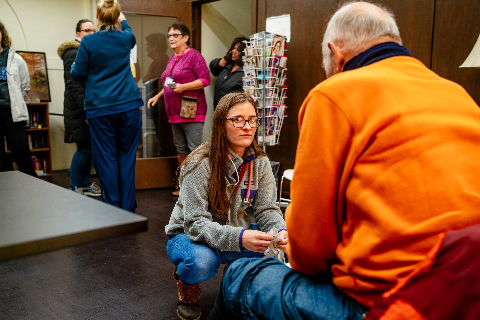 Sarah Cornwell, physician's assistant, tends to a man at St. Peter and Paul Jesuit Church. 