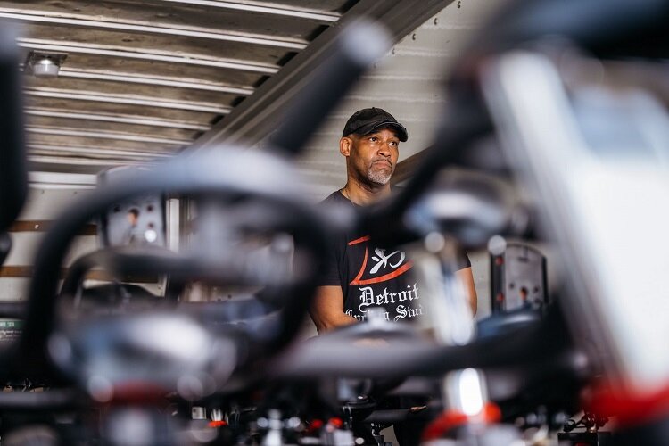 Tyronza Nesbitt stands with some of Detroit Cycling Studio's bikes.
