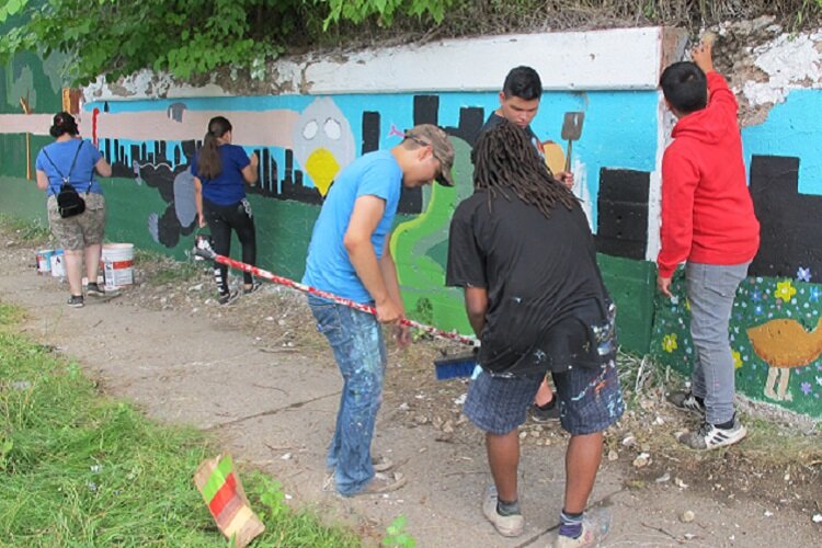 Youth with SUAMP paint a mural in pre-pandemic SW Detroit.