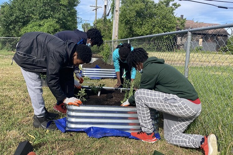 Youth plant a garden at Bailey Park.