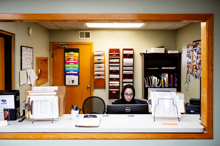 HUDA clinical volunteer Kinda Turaani works the front desk.