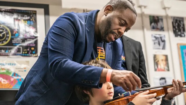 Damien Crutcher, managing director of Detroit Harmony, at an instrument distribution at Detroit Prep