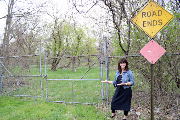 Galesburg mayor Lori West at the end of Mill Street. For the Kalamazoo River Valley Trail length through Galesburg, the gates will come down and the trail will meander through the trees along the Kalamazoo River.