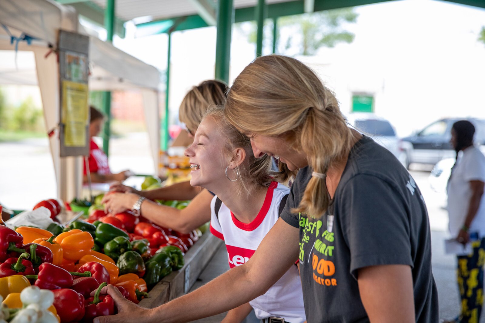 A Farmers Market Food Navigator assists shoppers at the Muskegon Farmers Market.
