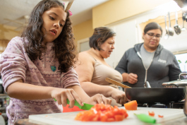 Eleanor Moreno (on right) cooks with her mother, Maria Moreno-Reyes, and niece, Iliana Basulto.