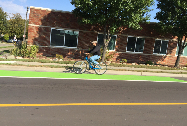 A cyclist rides in a bike lane on W. 9 Mile Road in Ferndale