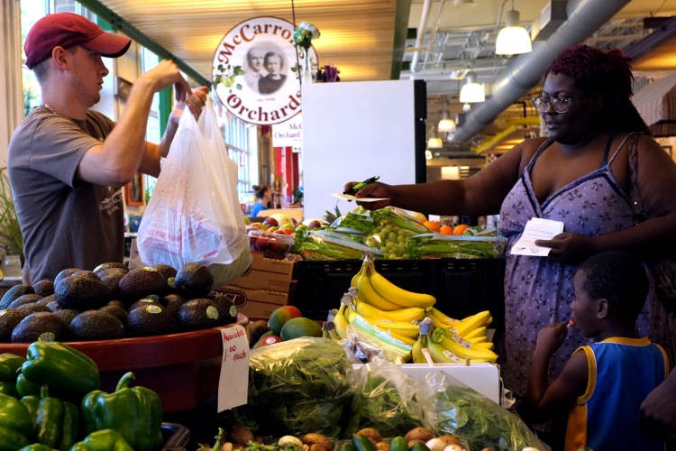 Geamill Gibson and her son buy produce using a doctor's prescription at the Flint Farmers Market.