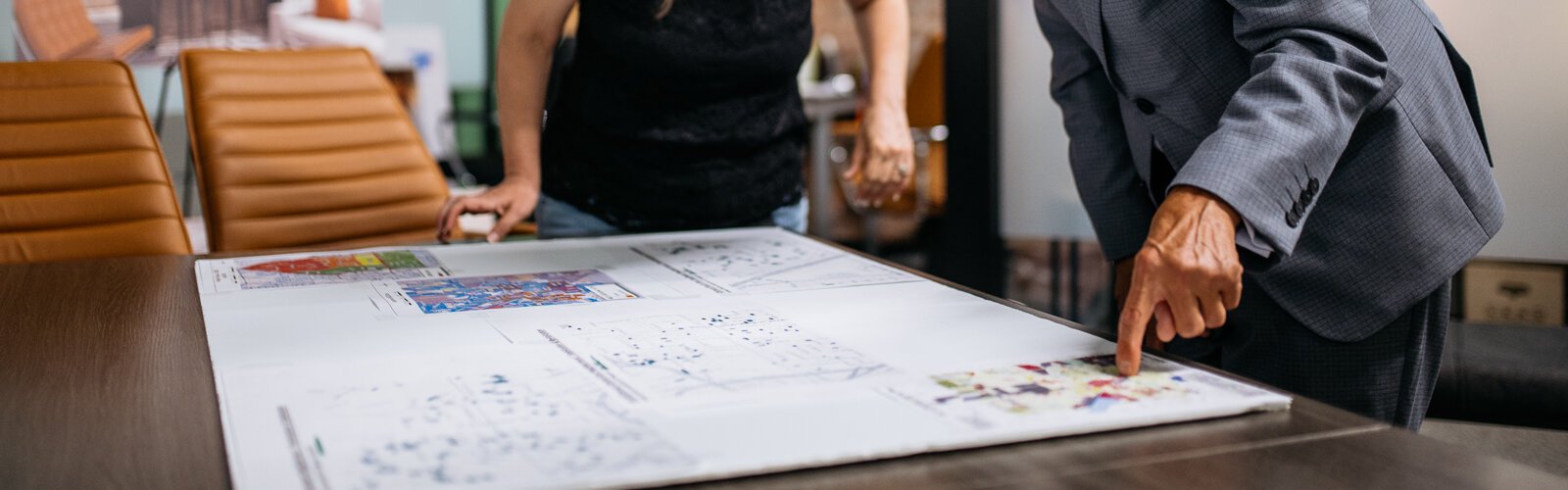 Leah DuMouchel, director of programs and communications at the Michigan Association of Planners, and Vern Gustafsson, project director/planner at the Pontiac Housing Development Corporation, look over zoning maps.