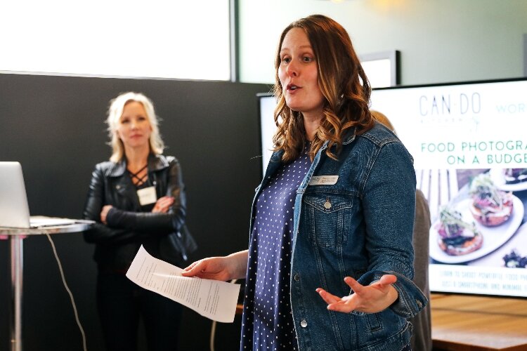 Sheena Foster, of Can-Do Kalamazoo, speaks as Lindsay Broveleit, from Newhall Klein (now Matato), looks on. 