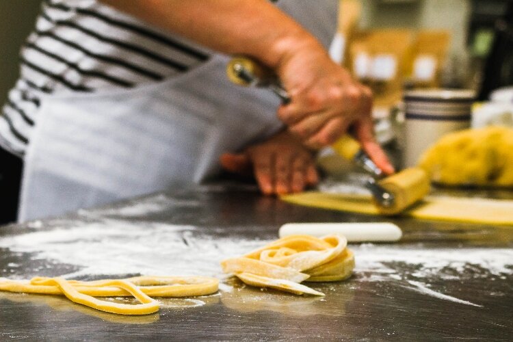 Julie Arch, a previous Can-Do Kalamazoo member, makes pasta. 