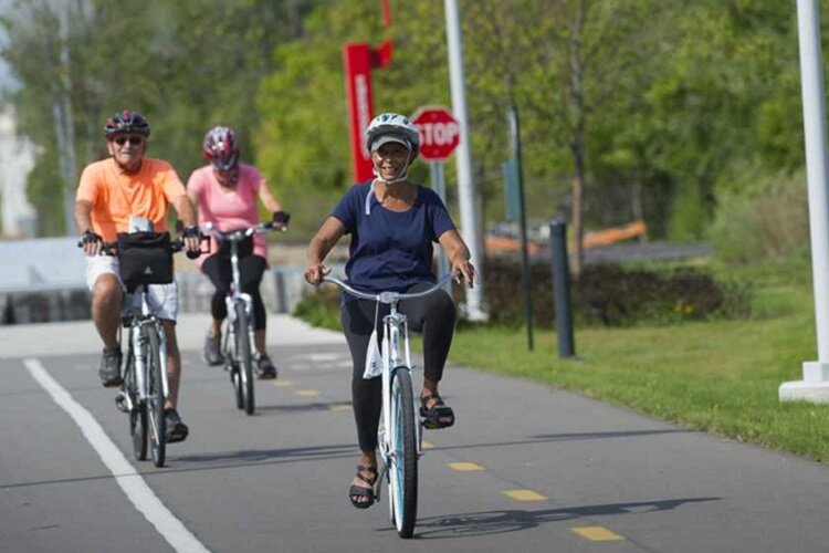 Bicyclists enjoy a greenway in Detroit.