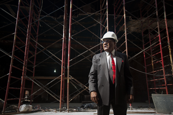 A wall of scaffolding behind George Stewart in the lobby of the Garden Theatre.