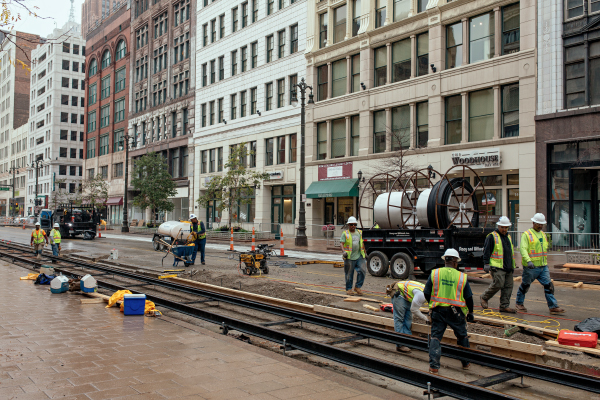 Construction workers busy on a stretch of M-1 along Merchants Row in downtown Detroit