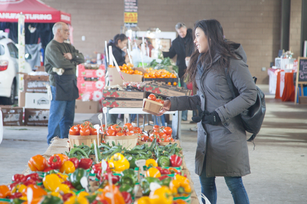 A woman purchases Leaminton produce at Eastern Market