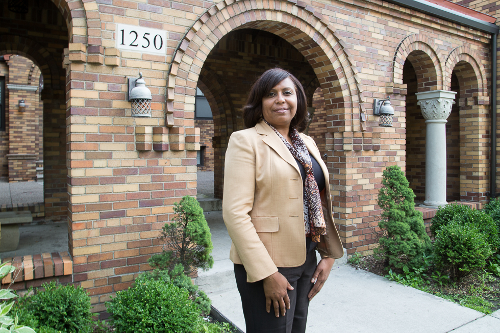 Tahirih Ziegler, executive director of Detroit LISC, in front of the Whitdel Apartments in southwest Detroit