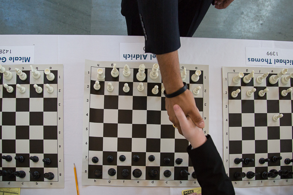 A young player shakes hands with Grandmaster Hikaru Nakamura 