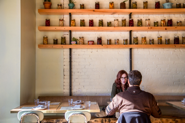 Patrons of Gold Cash Gold sit below jars of preserves