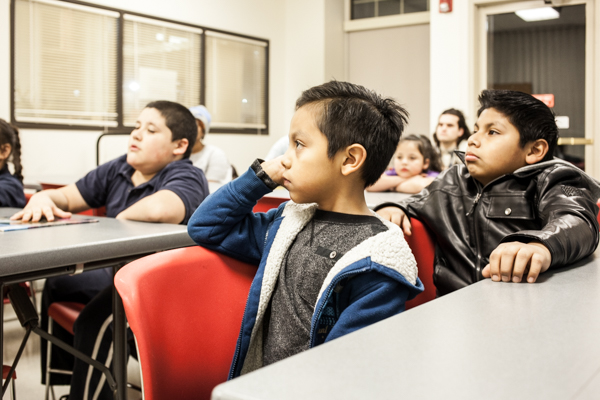 Kids participate in an 826Michigan leads a writing workshop at the Campbell Branch Library