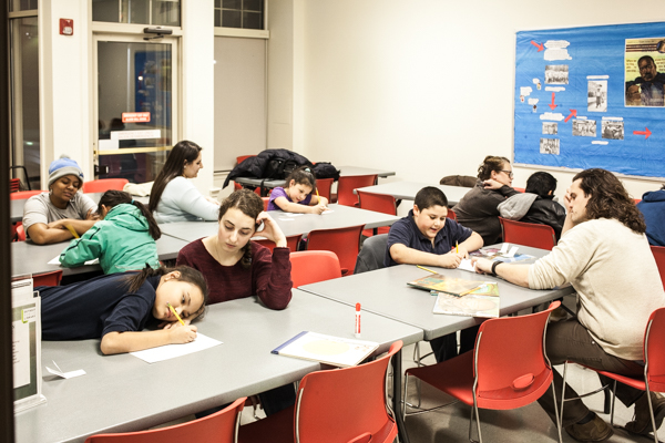 Young writers work with volunteers at an 826Michigan writing workshop at the Campbell Branch Library